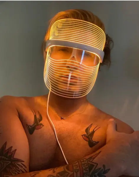 Man using amber light Derma Therapy Mask