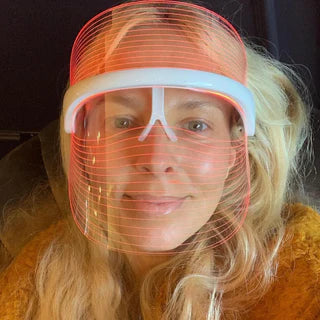 blonde woman using redlight Derma Therapy Mask