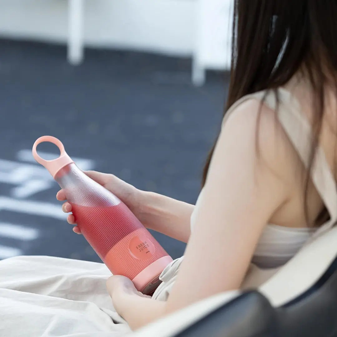 woman holding Portable Burgundy Blender with two hands
